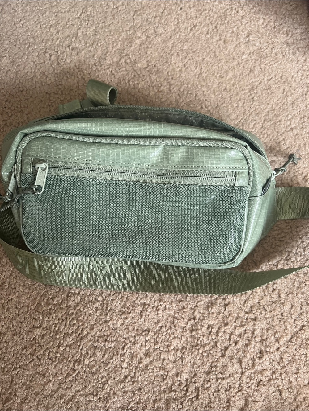 Calpak sage green belt bag with logo strap
